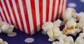 Image of box of popcorn over white spots Royalty Free Stock Photo