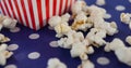 Image of box of popcorn over white spots Royalty Free Stock Photo