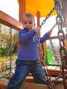 Boy crossing bridge at the playground