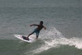 The boy control the surf board as he learn surfing in Lagos popular beach, Tarkwa bay, Lagos Nigeria Royalty Free Stock Photo