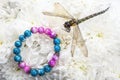 Image of bracelet dragonfly flower background