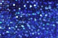 Abstract Dark Blue Christmas Holiday Background with Bright Blurred Bokeh and Glowing Sparkles Royalty Free Stock Photo