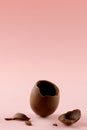 Image of broken chocolate easter egg and copy space on pink background Royalty Free Stock Photo