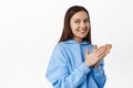 Image of brunette cunning girl rub hands, smiling and looking aside at sale banner with thoughtful, interested face Royalty Free Stock Photo