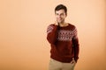 Image of brunette man 20s with bristle wearing knitted sweater s