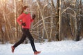 Image of brunette in sports uniform on morning run in winter Royalty Free Stock Photo