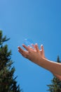 A bubble soap in hands against a blue sky Royalty Free Stock Photo