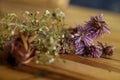 Bunch of dried daisies and other flowers on wooden table top with copy space Royalty Free Stock Photo