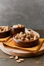 Image of bunch of peanuts in a bowl on a wooden table Royalty Free Stock Photo