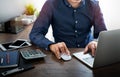 Image of Businessman using mouse computer and typing keyboard of laptop computer notebook on office desk. Royalty Free Stock Photo