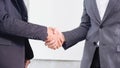 Image of businessmen is shaking hands, businessman agrees to be the same cooperate in order to step through away the bad economy t