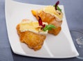 Camembert cheese on a mini croissant, french dessert at plate