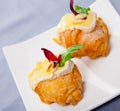 Camembert cheese on a mini croissant, french dessert at plate