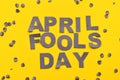 Image caption April Fools' Day of grey letters on a yellow background close-up, around confetti