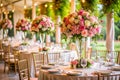 Wedding Banquet Tables Decorated with Tall Floral Centerpieces and Gold Chairs in an Outdoor Setting Royalty Free Stock Photo