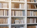 White Wooden Bookcase in Public Library with Colorful Books Royalty Free Stock Photo