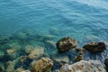 a picture of a rocky cliff with a blue water and some rocks Royalty Free Stock Photo