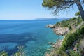 a picture of a rocky cliff with a blue water and some rocks Royalty Free Stock Photo