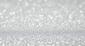 Shimmering silver glitter surface with bright bokeh Royalty Free Stock Photo