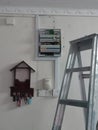 Electrical Panel and Ladder Setup on a Textured Wall Royalty Free Stock Photo