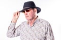 Stylish Elderly Man Adjusting Fedora Hat Royalty Free Stock Photo