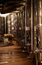 the inside of a wine brewery with many racks and a small tank Royalty Free Stock Photo