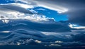 Majestic Layered Clouds and Blue Sky. Dynamic Atmospheric Cloudscape with Powerful Weather Formations. Royalty Free Stock Photo
