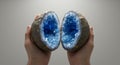 Sapphire Cavern A Fractured Geode Reveals Blue Crystal Splendor Cradled by Hands Royalty Free Stock Photo