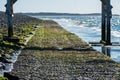 Coastal Pathway with Pier Pillars Overlooking Sea Royalty Free Stock Photo