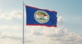 The national flag of belize waving proudly against a backdrop of fluffy white clouds and a blue sky Royalty Free Stock Photo