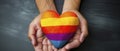 Person Holding Rainbow Heart, Symbol of Love and Acceptance