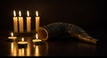 Shofar and candles illuminate the dark space Royalty Free Stock Photo
