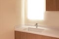 Elegant Wooden Bathroom with White Laminated Sink and Mirror