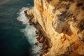 brown rock cliff formation. steep cliff. teal water ocean with white foam waves. Skansbukta Royalty Free Stock Photo