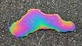 A vibrant oil spill on a dark asphalt surface creates a beautiful rainbow effect Royalty Free Stock Photo