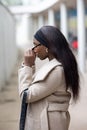 Contemplative Moment: Young Black Woman in a Stylish Winter Coat Royalty Free Stock Photo