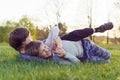 Boy trying to grab and immobilize comrade who wrinkled face attempting to win, friends fighting and playing on meadow.