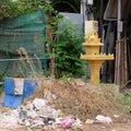 Image capturing a small religious shrine situated in a garbage dump within Cambodia