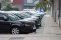 Cars parked in a row on a city street Royalty Free Stock Photo