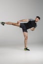 Image of caucasian athletic man kicking while working out