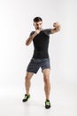 Image of caucasian athletic man in sportswear hitting while working out