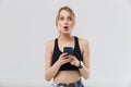 Image of caucasian blond woman 20s dressed in sportswear using smartphone during workout in gym Royalty Free Stock Photo