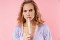 Image of caucasian displeased woman eating marmalade