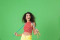 Image of caucasian woman 20s wearing summer clothes working out and doing exercises with jumping rope Royalty Free Stock Photo