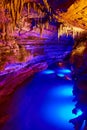 Cave tour in midwest of river with blue lights and formations of stalactites