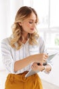 Image of charming elegant secretary woman holding clipboard in office