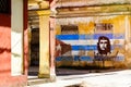 Image of Che Guevara and a cuban flag on an old building in Havana