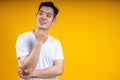 Image of cheerful young Asian man in basic clothing laughing looking aside