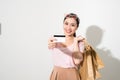 Image of cheerful young woman standing isolated over white background holding shopping bags and credit card. Looking camera Royalty Free Stock Photo