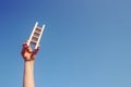 Image of child hand holding a ladder against the sky. education and success concept. Royalty Free Stock Photo